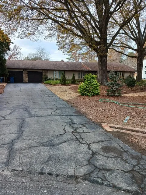 Driveway and walkway cleared of leaves after fall cleanup.
