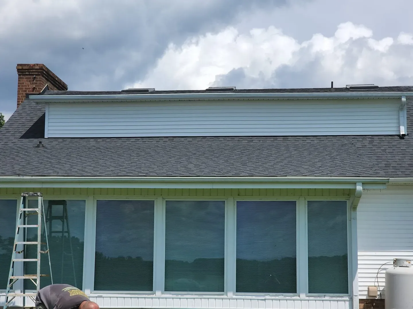Repaired gutter secured along the edge of a roof.